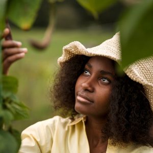 front-view-woman-checking-plant_23-2149894742